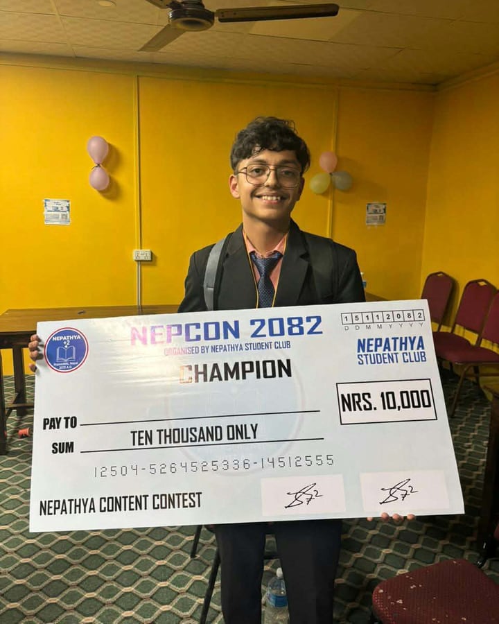 Dipin holding the NEPCON 2082 champion cheque